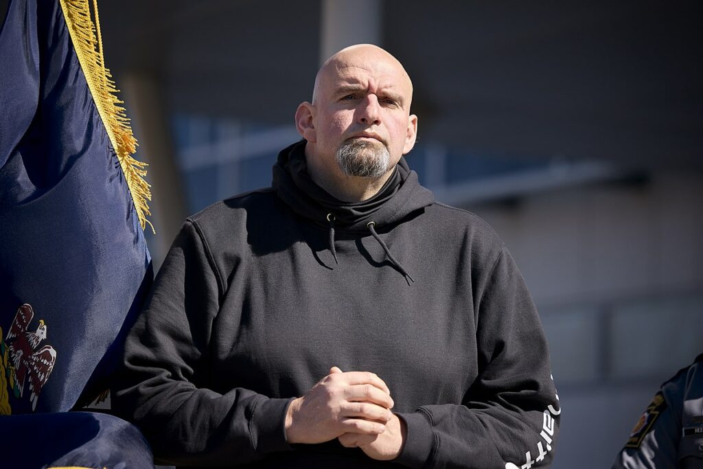 John Fetterman listening to speakers