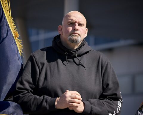 John Fetterman listening to speakers