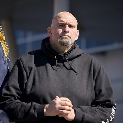 John Fetterman listening to speakers